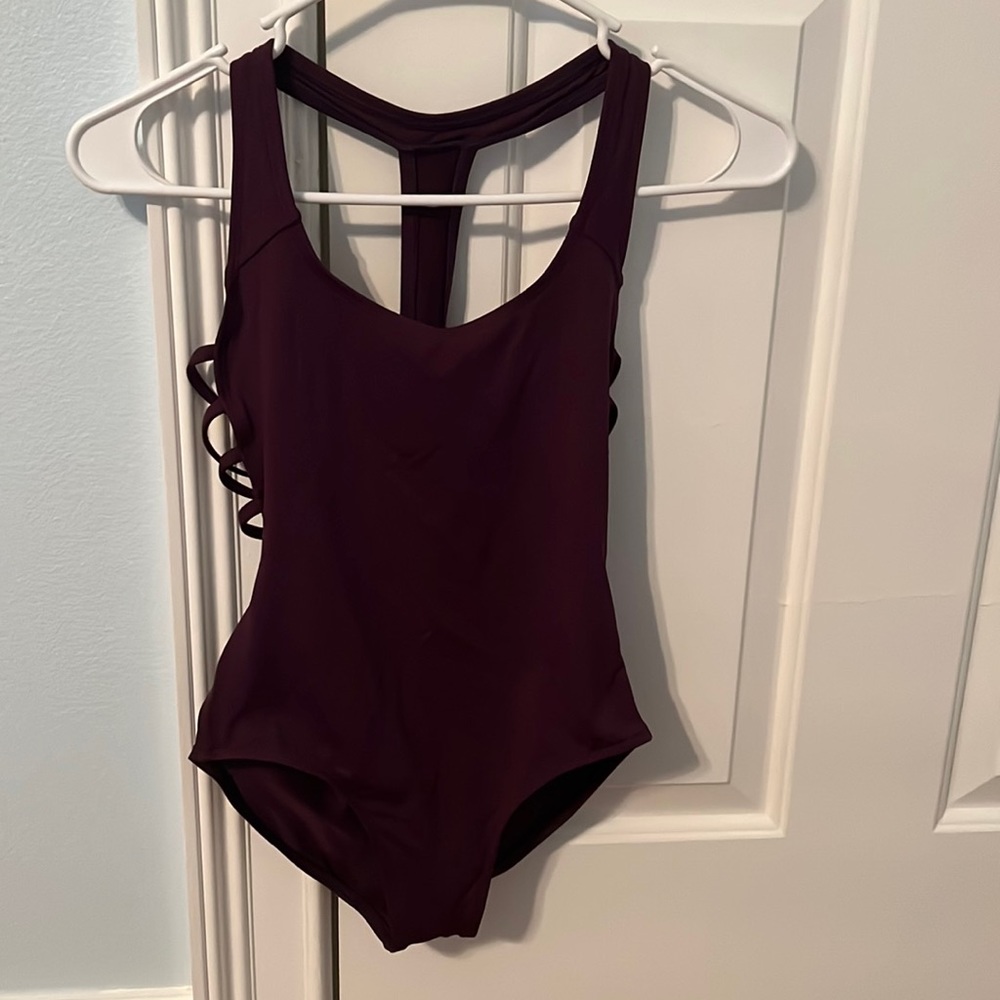 Dance leotard with racer T and strappy side backing. Plum color. XS